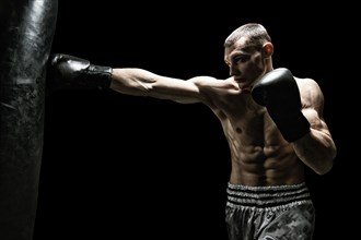 Professional boxer hits the bag. The concept of sport