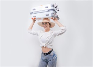 Beautiful girl carries a suitcase on her head on a white background. Tourism concept.