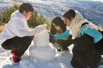 Frosty Delights Latino Family Bonds While Creating Snowman Memories in Sierra Nevada