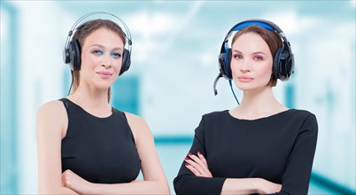Image of two attractive women with headsets. TV shopping concept.
