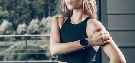 Charming girl posing with a smart watch. No name portrait. The concept of bodybuilding