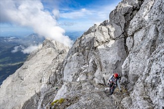 Mountaineer on a narrow rocky mountain path