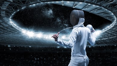 Portrait of a fencer against the backdrop of a sports arena. The concept of fencing. . Back view