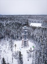 Viewing tower in the middle of a snow-covered forest