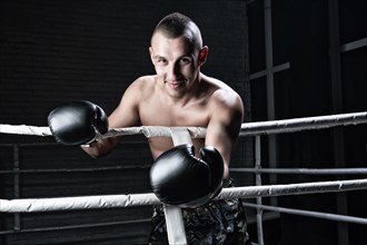 Portrait of kickboxer occupying an opponent in the ring. Sports concept