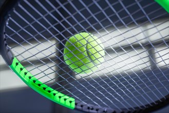 Image of a tennis ball on a racket. Sports concept.