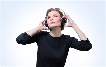 Portrait of a woman in professional headphones. White background. Dj concept.