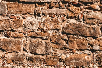 Wallpaper of a stone wall. Ancient slightly destroyed stone. Florence.