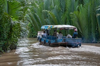 Boat between water palms
