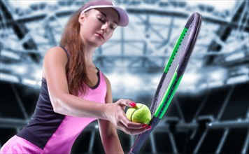 Portrait of a tennis player in a pink dress against the background of a sports arena.