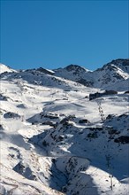 View of a snow track in Sierra Nevada Spain with chairlifts
