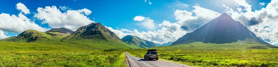 Panorama of Glen Etive and SUV BMW X3 with a roof tent