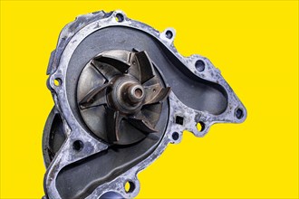 Car water pump on yellow isolated background