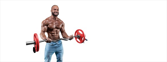 Athlete posing on a white background in jeans with a barbell in his hands. Fitness