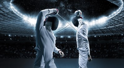 Portrait of two fencers against the backdrop of a sports arena. The concept of fencing. Duel.