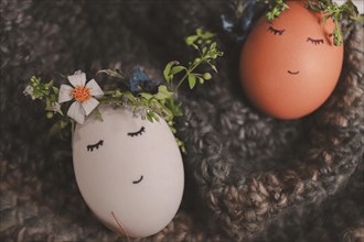 Playful painted eggs with faces and floral decorations