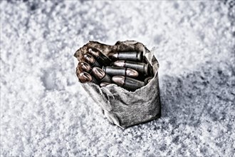 Package of ammunition is thrown into the snow.