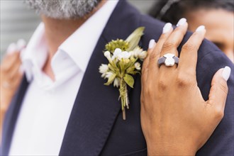 Multiethnic couple embracing with ring at a beautiful wedding