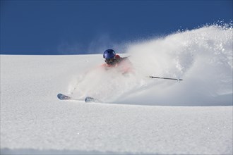 A skier making a turn in deep snow