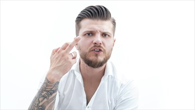 Stylish bearded man shows middle finger to the camera. The concept of failure