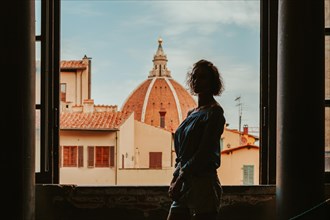 Charming woman stands in the Palazzo Vecchio against the background of the basilica. Tourism and travel concept.