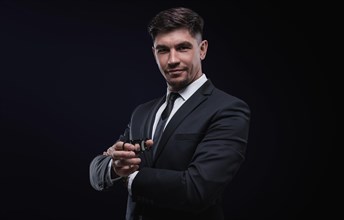 Portrait of a stylish man in a suit with a cigar. Business concept.