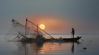 Fisherman attended to his net on a still water surface during a warm sunset