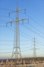 High-voltage pylons in a field