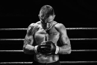 Mixed martial artist posing on a black background. Concept of mma