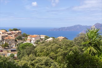 The Corsican village of Piana with the rocky coast of the Gulf of Porto in the background