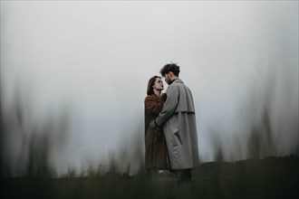 Couple in love in a foggy field. Relationship crisis and dramatic love concept