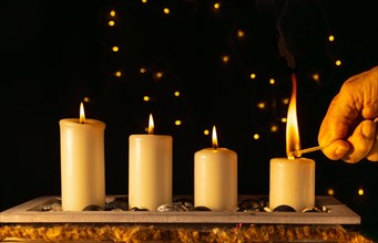 Light the fourth Advent candle with a match