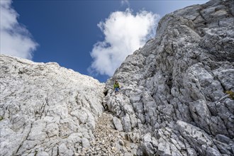 Mountaineer in steep rock face