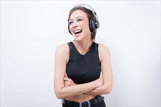 Portrait of a laughing woman in headphones. Musical accessories concept.