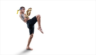 Portrait of a Thai boxer. He hits with a knee on a white background. Competitions and tournaments concept.