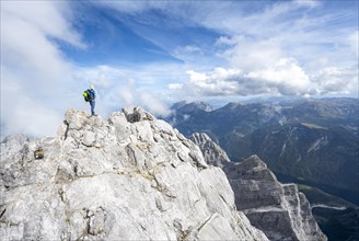 Mountaineer on a narrow rocky ridge