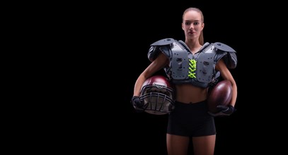 Portrait of a girl in the uniform of an American football team player. Black background. Sports concept.