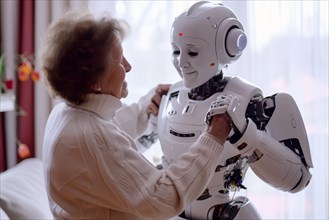 Elderly woman dancing and having fun with a friendly white care robot