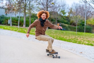 Photo with motion and copy space of a happy young man skateboarding in an urban park