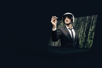 Portrait of a man in a suit and helmet. He launches a paper airplane from a laptop screen. Web Design Concept.