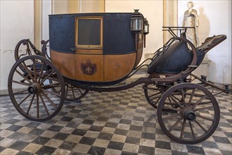 Historic horse-drawn carriage in the vestibule of the former royal palace