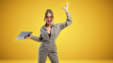 Portrait of a woman in a suit with a tablet. She waves her hand emotionally. Sports betting concept.