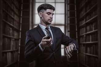 Portrait of an elegant man in a suit with a smoking pipe. Business concept.