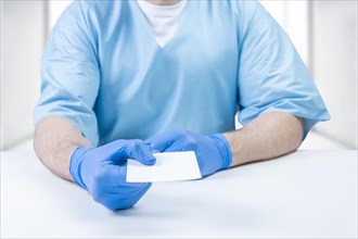 Doctor holds out a white sheet of paper. Medical concept.