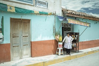 Woman in front of her devotional shop