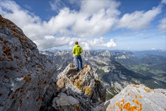 Mountaineer on the rocky Watzmann Hocheck summit