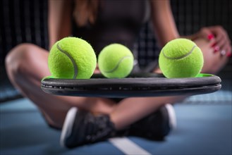 Image of a set of tennis balls lying on the strings of a racket. Sports concept.