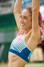Motivated sportswoman stretches and shows her fitness and vitality