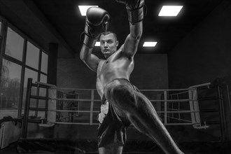 Image of a kickboxer in the gym. Knee kick. Mixed martial arts. Sports concept
