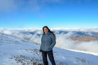 Portrait of latina woman in the snow above the clouds